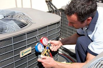 A technician providing an AC tune-up.