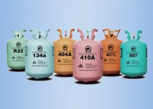 Multi-colored tanks of different kinds of refrigerant, on blue background.